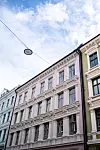 Her i denne rosa bygården er det 13 innflytningsklare leiligheter. I første etasje er det fellesarealet og kontorområde til de syv ansatte.