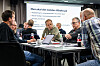 Seminardeltakere sitter rundt et bord foran en presentasjon om ny AFP-ordning.
